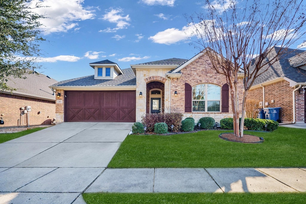 view of front of property with a front lawn and a garage