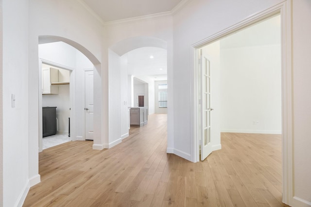 hall featuring ornamental molding and light wood-type flooring