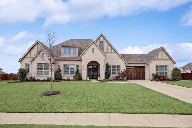 view of front of property with french doors and a front lawn