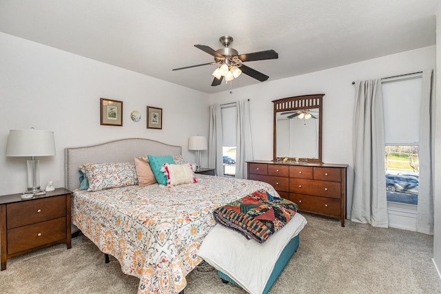 bedroom with ceiling fan and light carpet