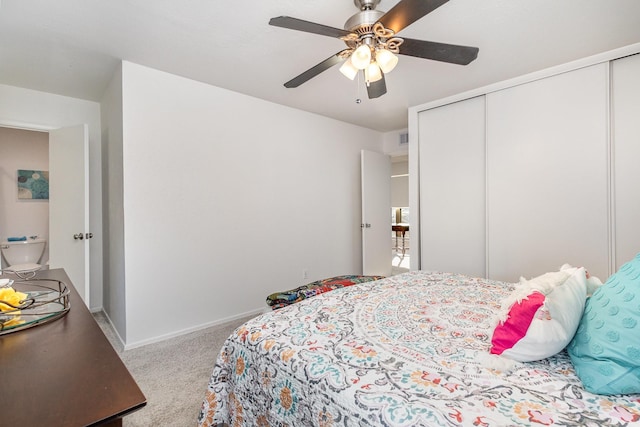 carpeted bedroom with a closet and ceiling fan