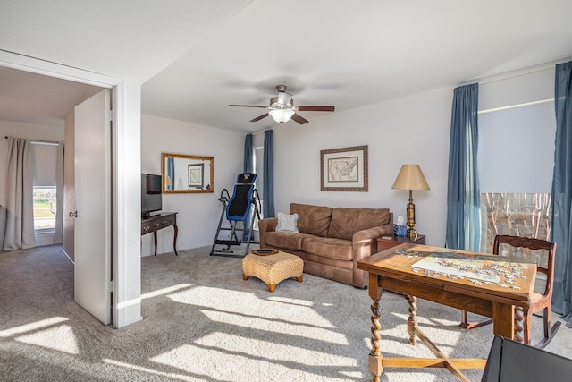 carpeted living room featuring ceiling fan