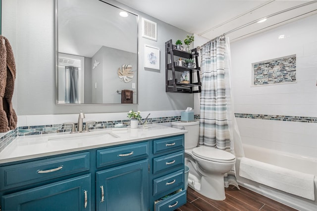 full bathroom with toilet, shower / bath combo with shower curtain, and vanity