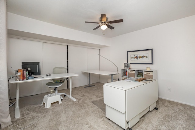 office space with ceiling fan and light colored carpet