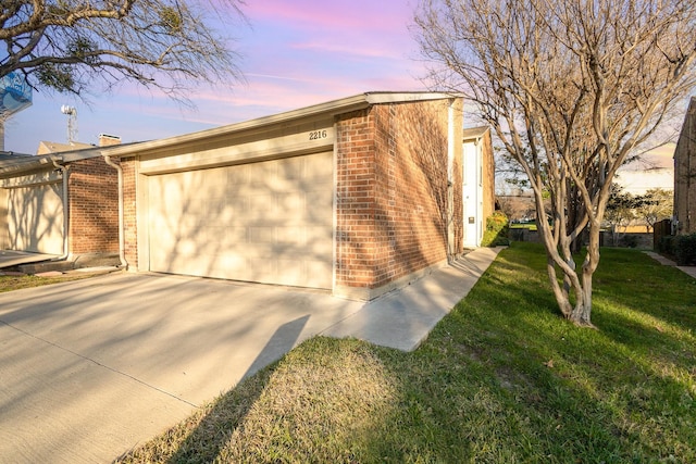 property exterior at dusk featuring a yard