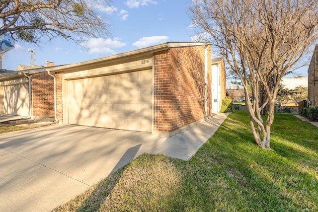 view of home's exterior featuring a yard and a garage