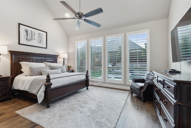 bedroom with vaulted ceiling, hardwood / wood-style flooring, ceiling fan, and multiple windows