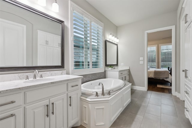 bathroom with a bathtub, tile patterned floors, and vanity