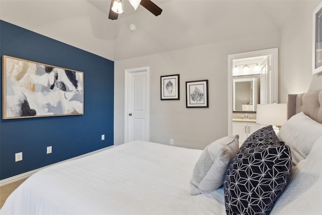 bedroom featuring ensuite bathroom, ceiling fan, and carpet