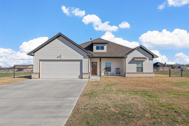 view of front of house with a front yard and a garage