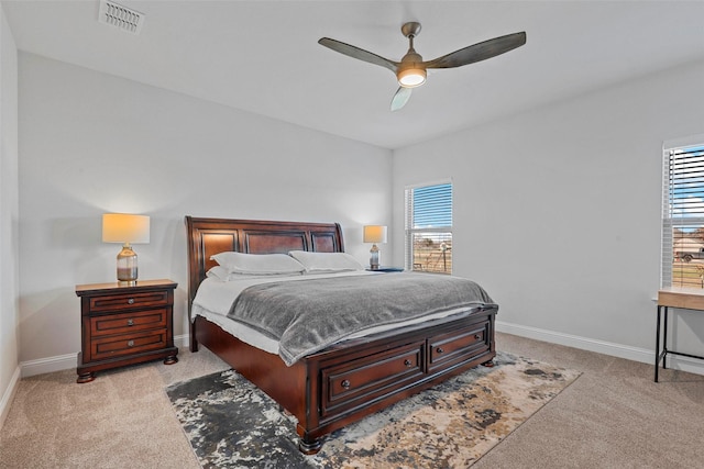 bedroom featuring light carpet and ceiling fan