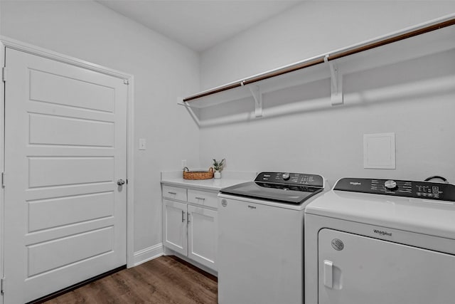 laundry area with washer and dryer, cabinets, and dark wood-type flooring