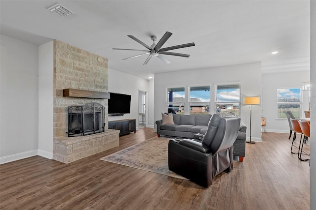 living room featuring a fireplace, ceiling fan, and hardwood / wood-style flooring