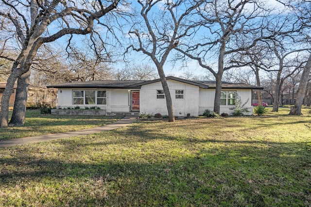 ranch-style home with a front lawn