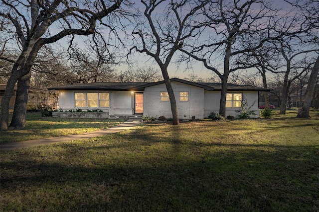 ranch-style house with a lawn