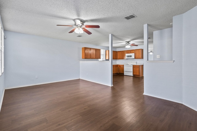 unfurnished living room featuring ceiling fan and dark hardwood / wood-style floors