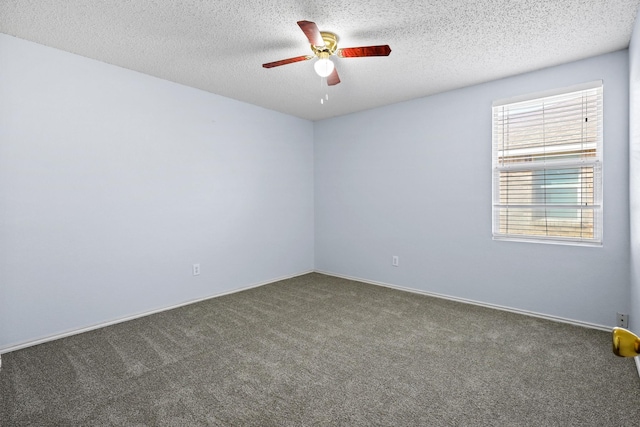 carpeted spare room featuring a textured ceiling and ceiling fan