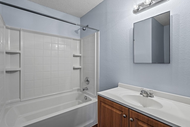 bathroom featuring a textured ceiling, shower / bathtub combination, and vanity