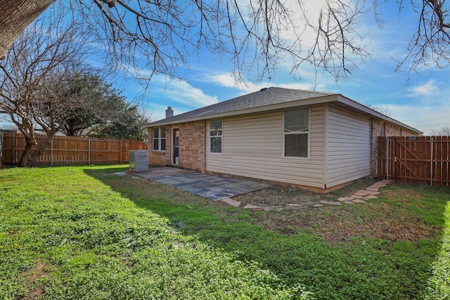 rear view of house with a patio area and a yard