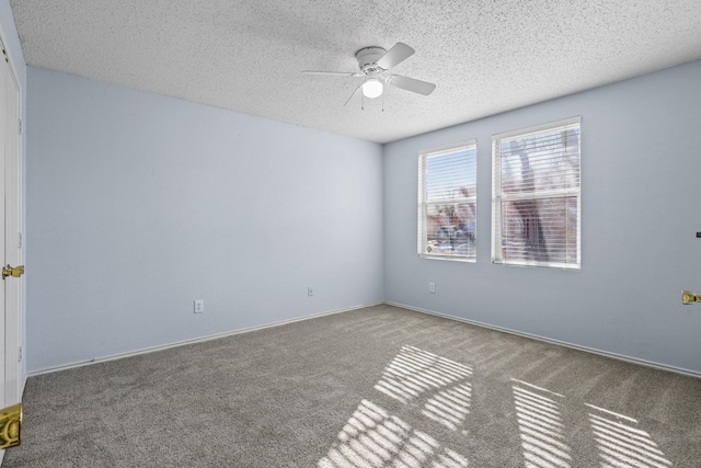 unfurnished room with a textured ceiling, ceiling fan, and carpet flooring