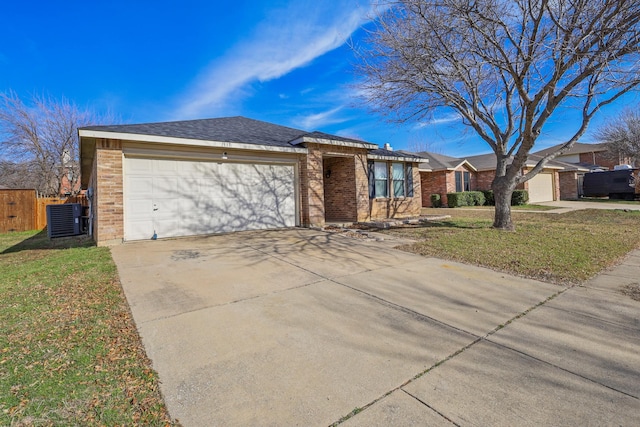 single story home featuring central AC unit, a front lawn, and a garage