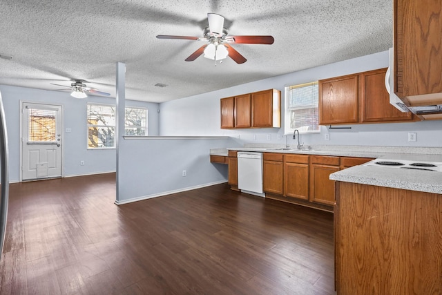 kitchen featuring a textured ceiling, dishwasher, dark hardwood / wood-style flooring, sink, and ceiling fan