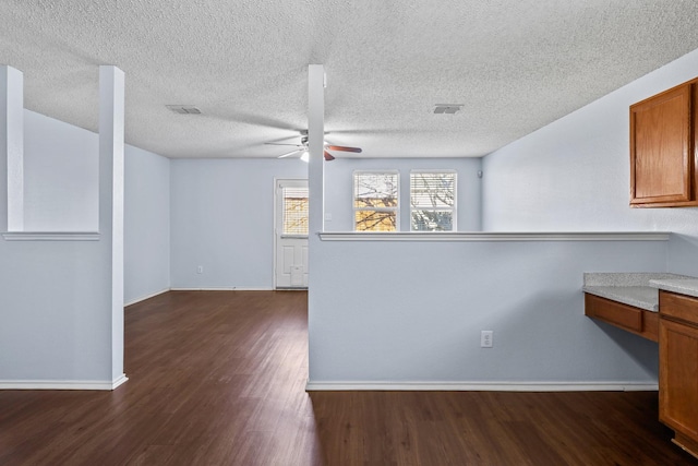 kitchen with ceiling fan, a textured ceiling, and dark hardwood / wood-style floors