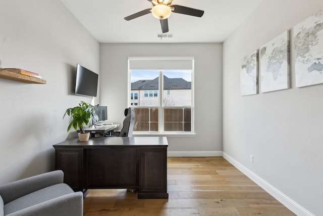 office space with light hardwood / wood-style floors and ceiling fan