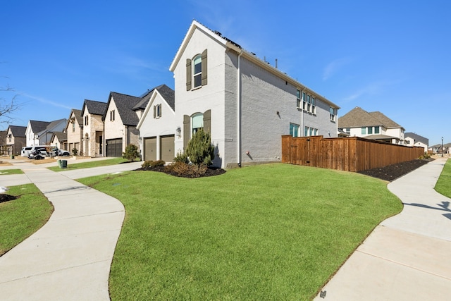 view of home's exterior featuring a lawn and a garage