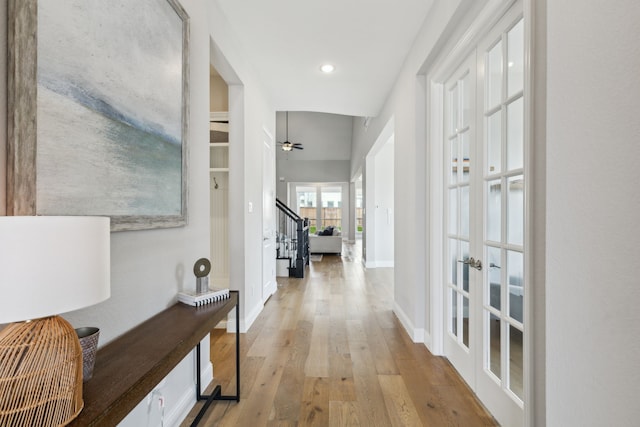 corridor featuring french doors and light hardwood / wood-style flooring