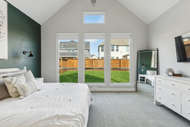 bedroom with lofted ceiling and light carpet