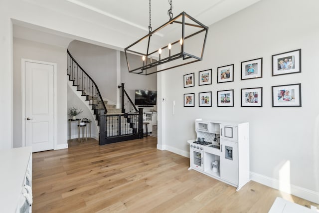 entrance foyer with a notable chandelier and light hardwood / wood-style flooring