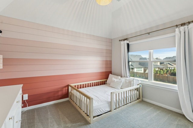 bedroom with vaulted ceiling and light carpet