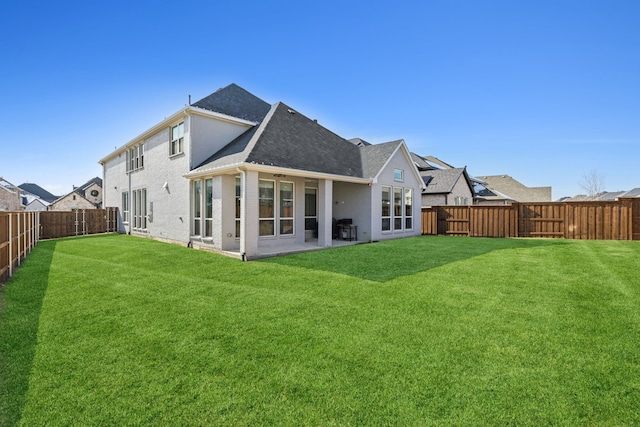 rear view of property with a patio and a lawn