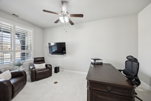 living area with light carpet, baseboards, visible vents, and a ceiling fan