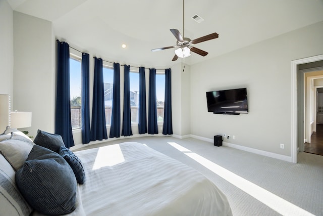 bedroom with light carpet, baseboards, multiple windows, and visible vents