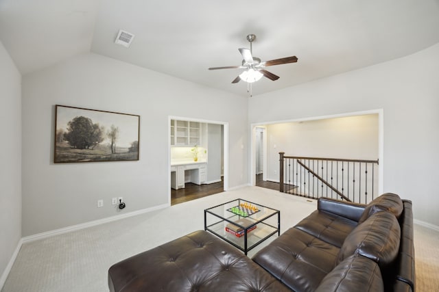 living area with vaulted ceiling, carpet flooring, visible vents, and baseboards