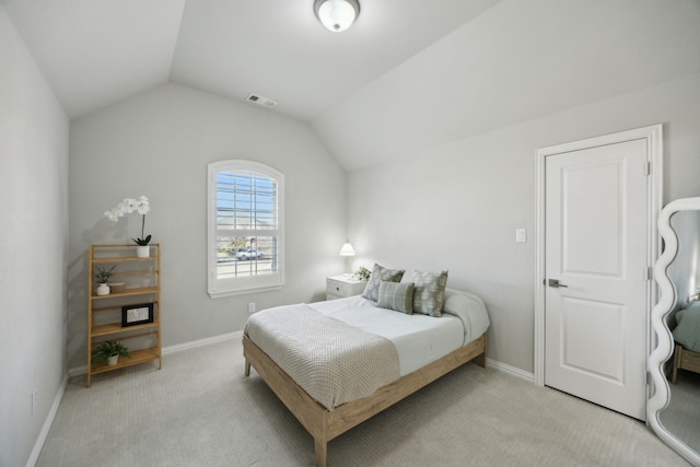 bedroom with light carpet, baseboards, visible vents, and vaulted ceiling