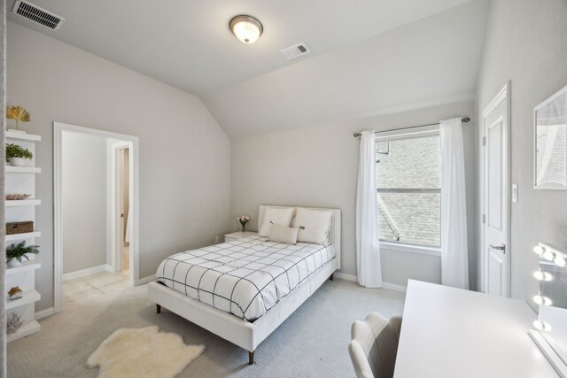 carpeted bedroom with vaulted ceiling