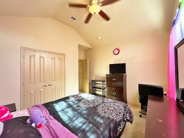 bedroom featuring vaulted ceiling, a closet, light colored carpet, and ceiling fan