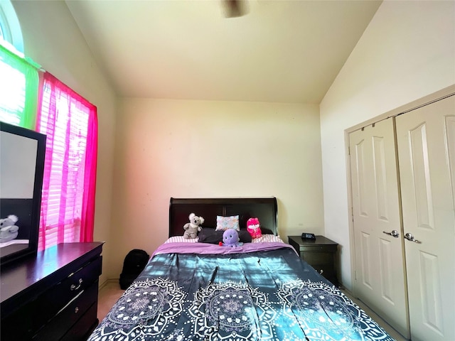 bedroom featuring vaulted ceiling and a closet