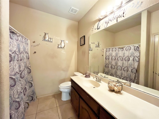 bathroom featuring toilet, vanity, and tile patterned floors