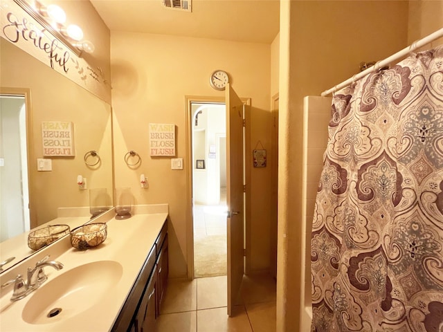 bathroom with tile patterned floors, vanity, and walk in shower