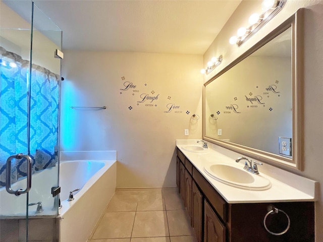 bathroom featuring tile patterned floors, a washtub, and vanity