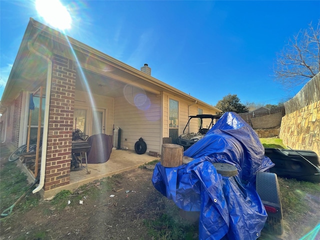 view of side of home featuring a patio area