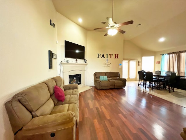 living room featuring ceiling fan, wood-type flooring, and high vaulted ceiling