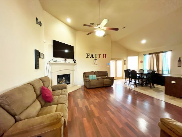 living room with ceiling fan, wood-type flooring, and high vaulted ceiling