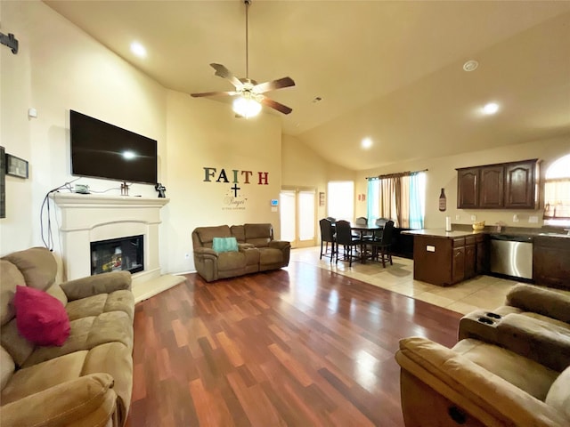 living room with high vaulted ceiling, light hardwood / wood-style flooring, and ceiling fan