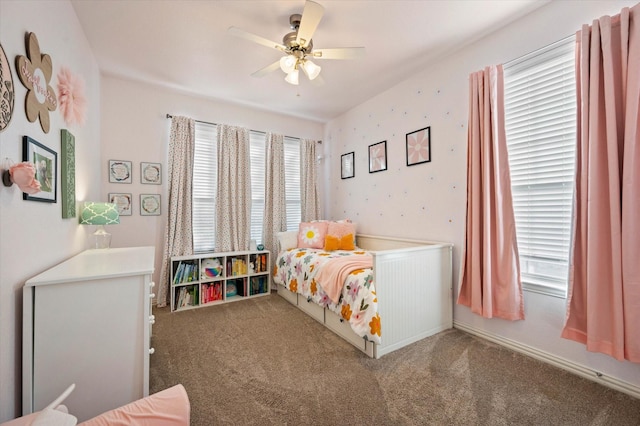 bedroom featuring ceiling fan, multiple windows, and carpet