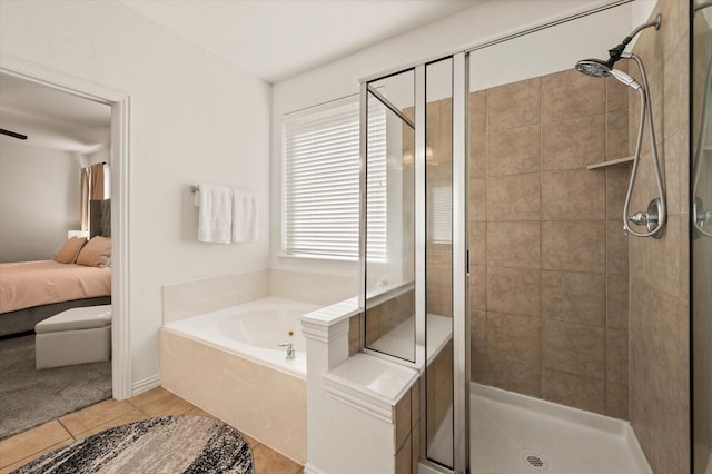 bathroom featuring tile patterned flooring and shower with separate bathtub